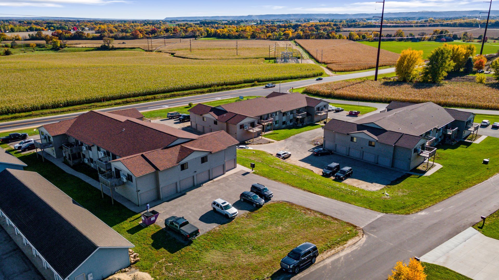 An aerial view of a residential area with a lot of houses and cars parked in front of them.