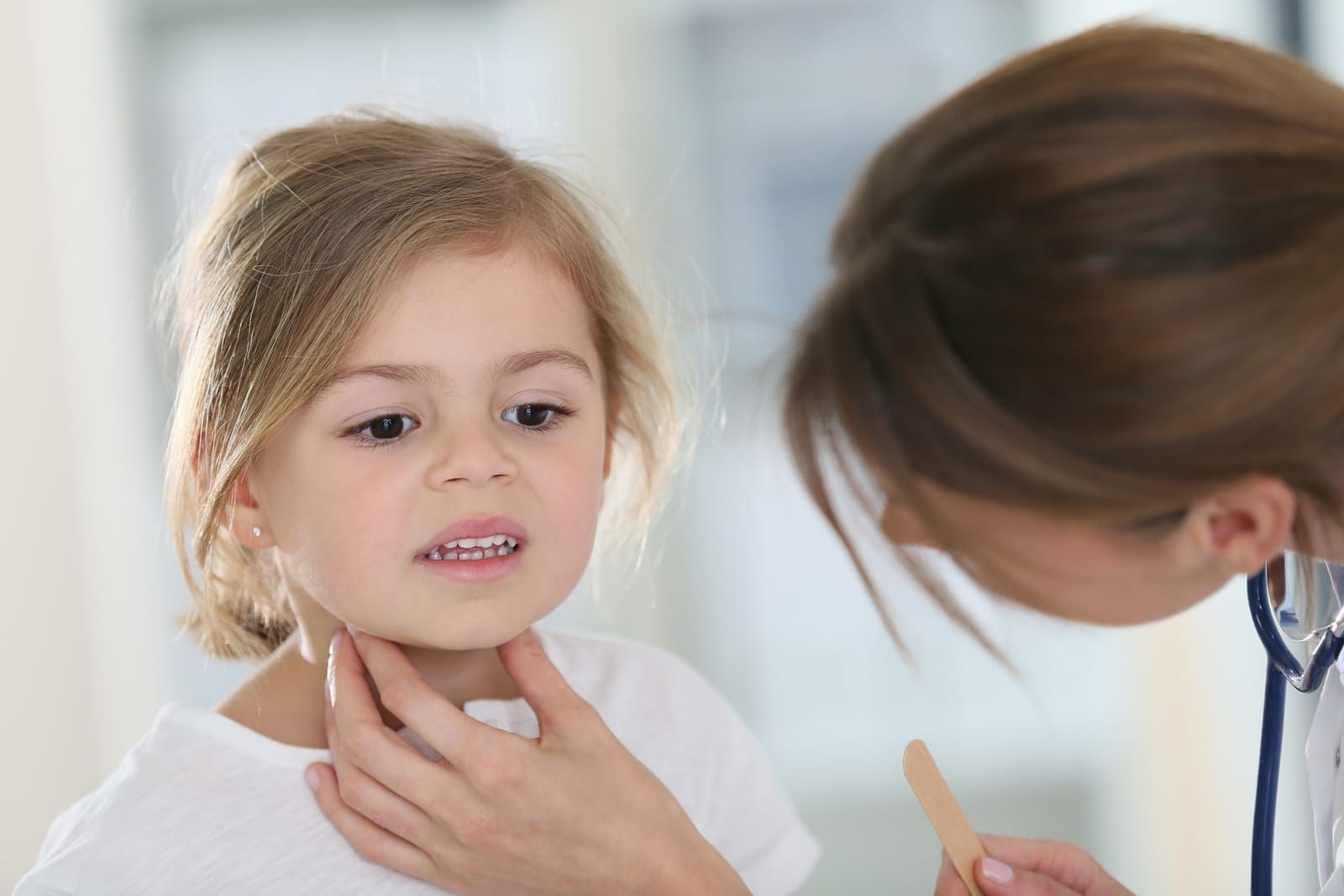 Doctor checking the  adenoids of a kid