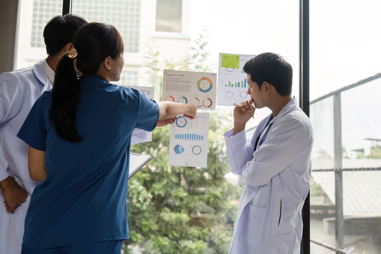 doctor-team-analyzing-health-charts-for-effective-patient-care