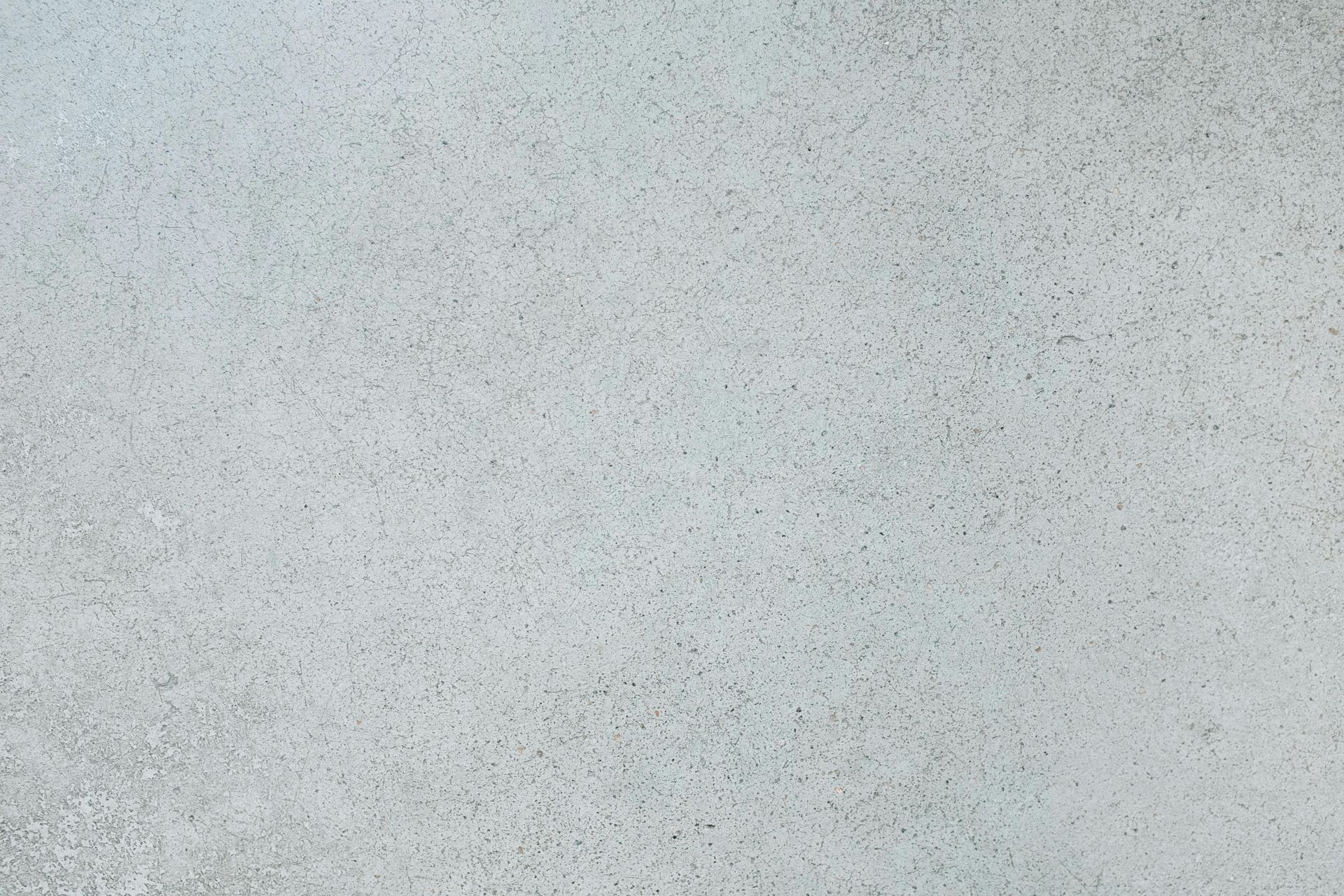 A close up of a white concrete surface with a grainy texture.