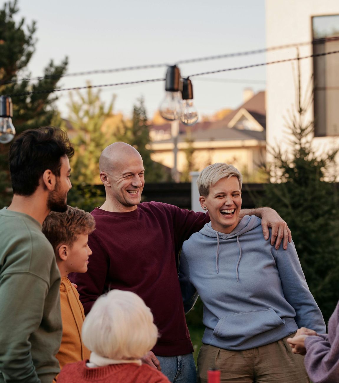 A group of people are standing next to each other and laughing.