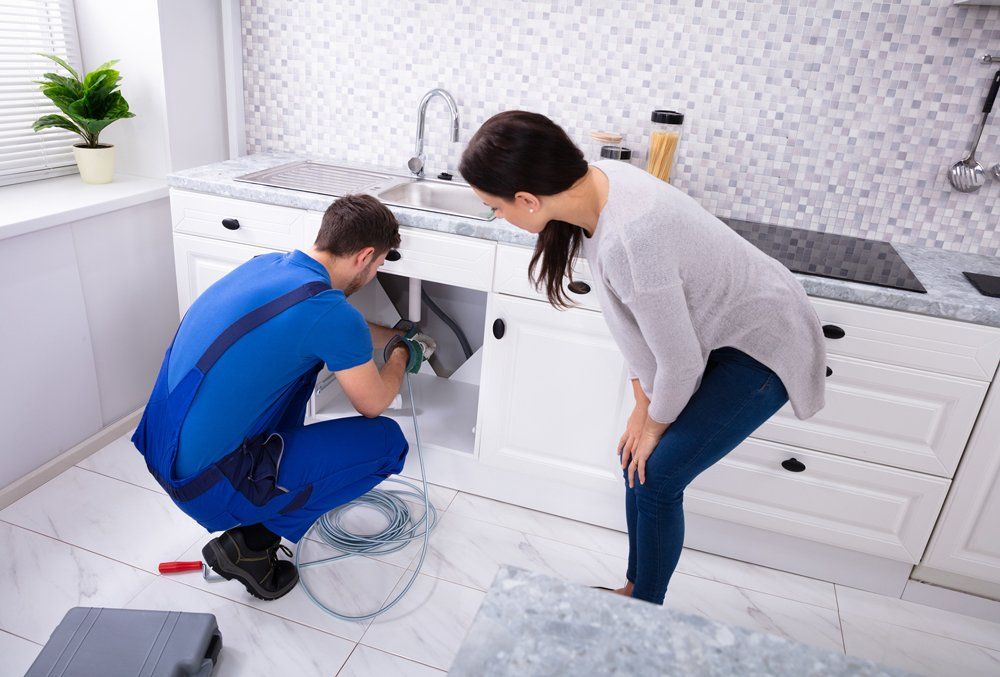 Man Repairing Sink Drain — Midland, TX — Randy's Rooter & Plumbing LLC