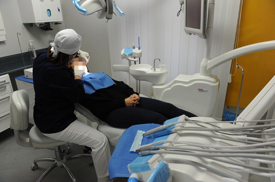dentist in his office examining a patient