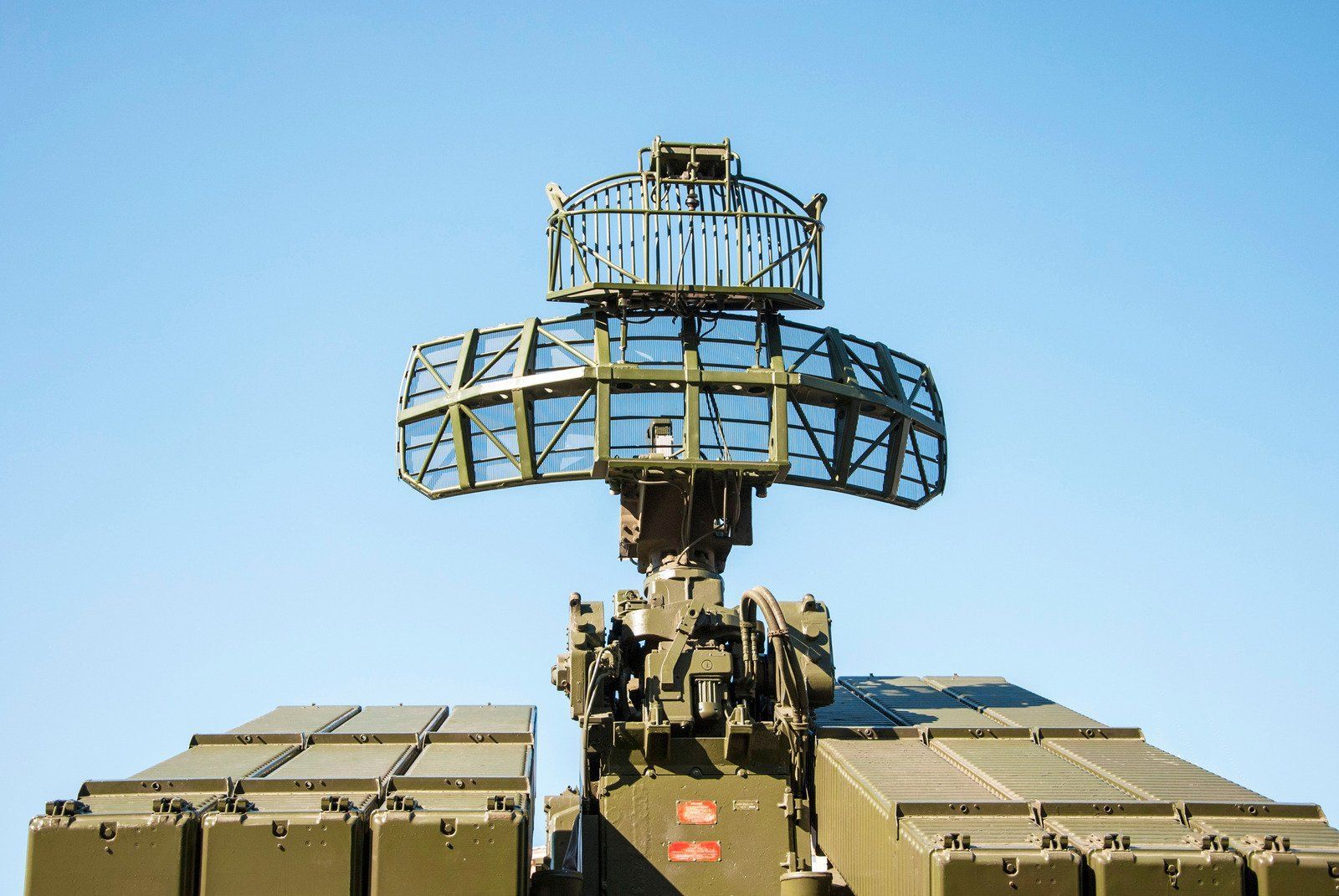 A military vehicle with a radar on top of it.