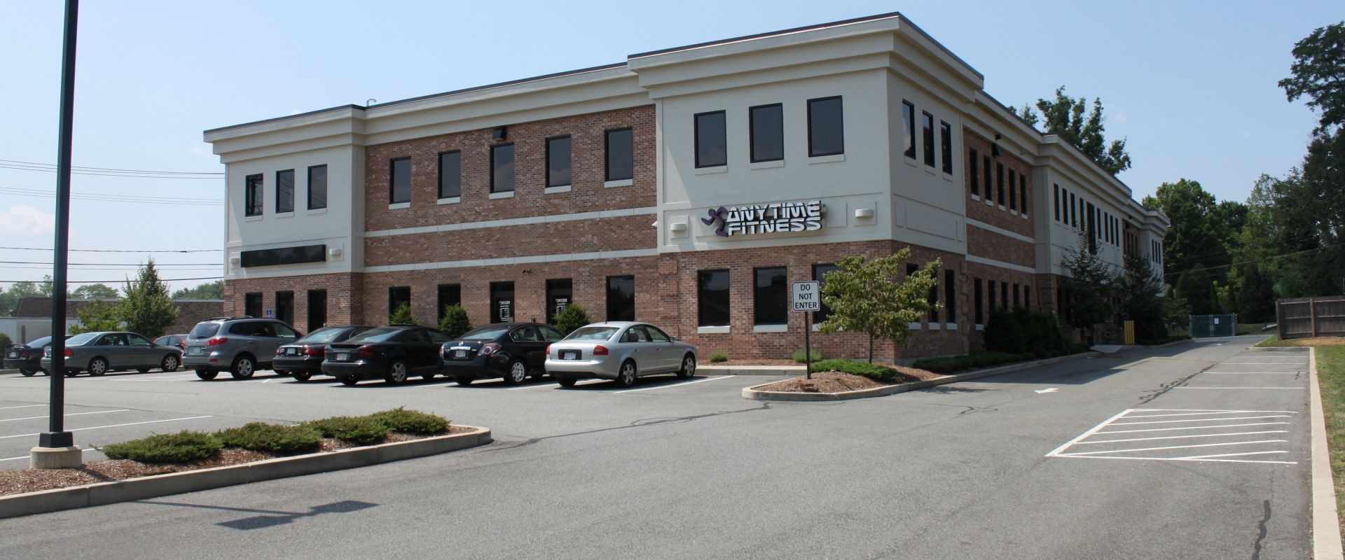 A large brick building with cars parked in front of it