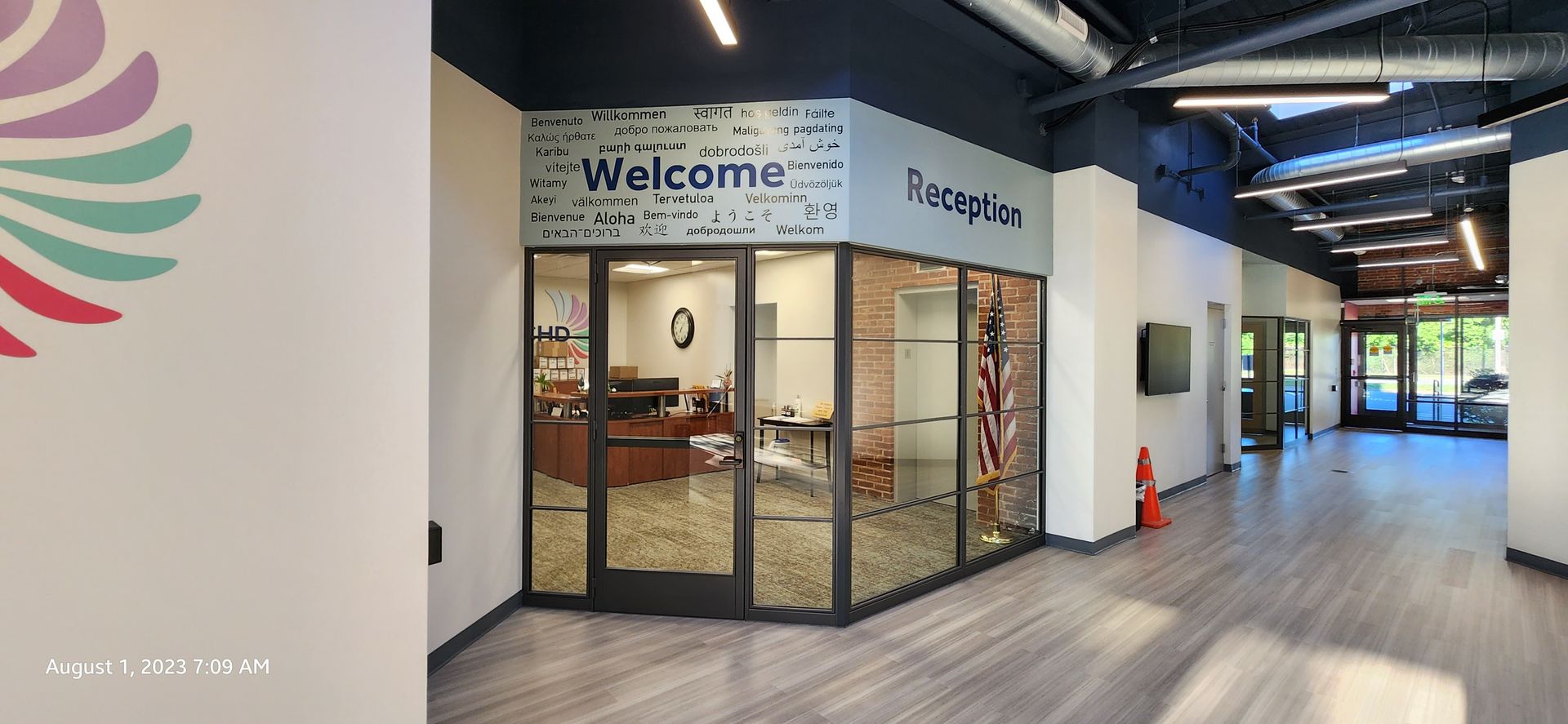 A picture of a lobby with a welcome sign on the wall.