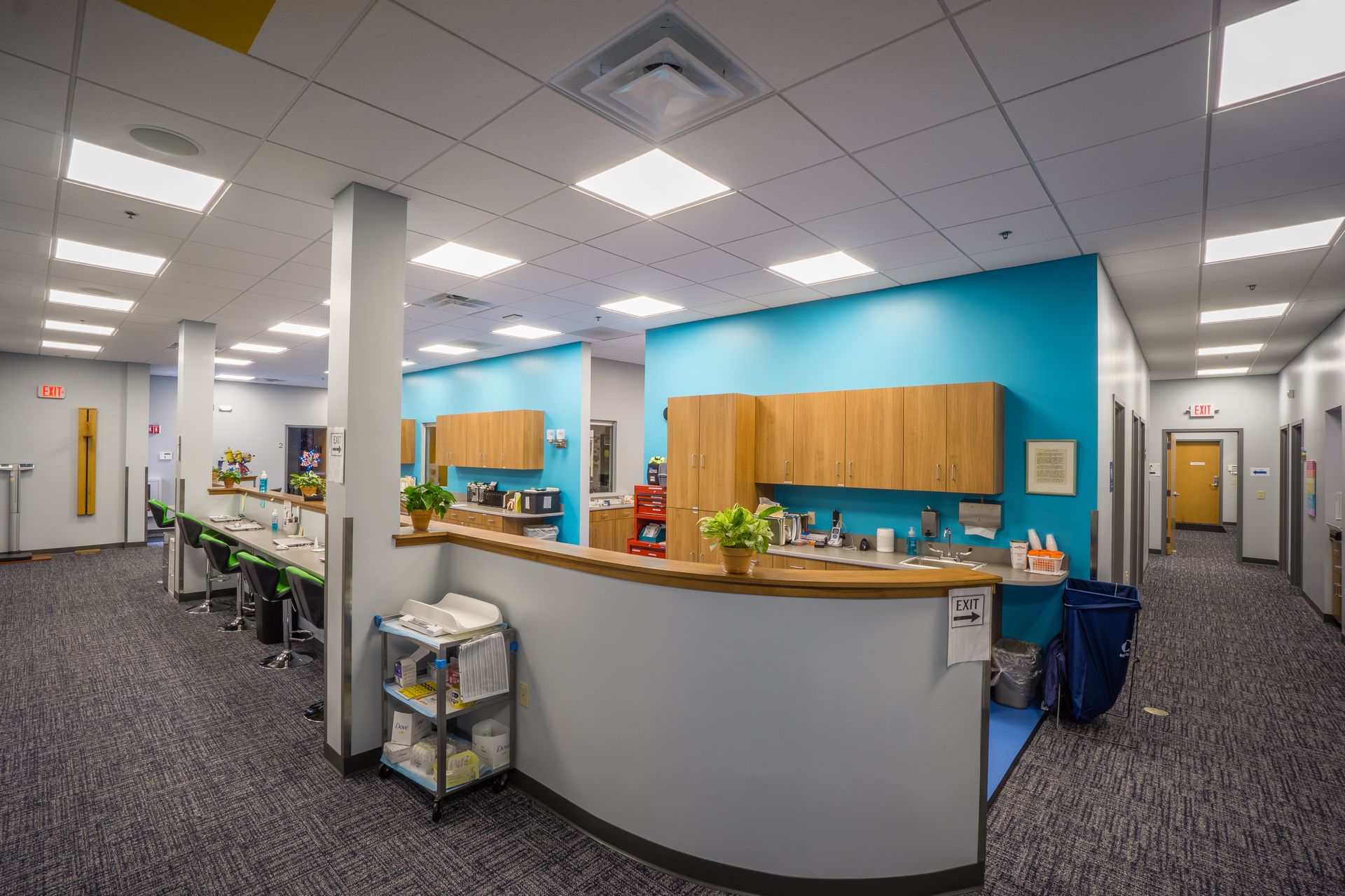 A large room with a blue wall and a counter in the middle.