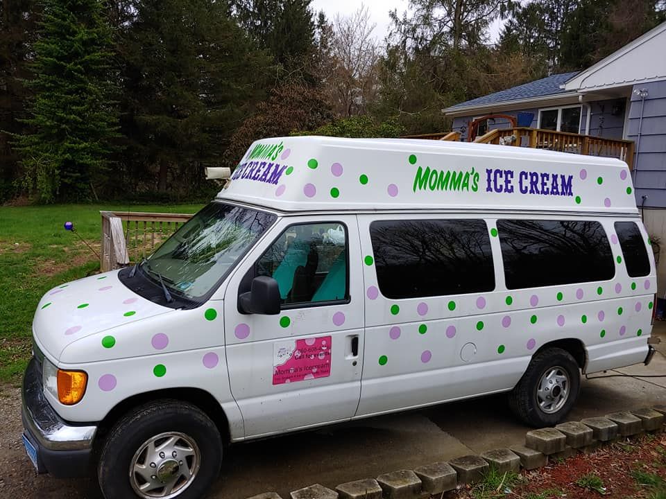 White van parked on a driveway with