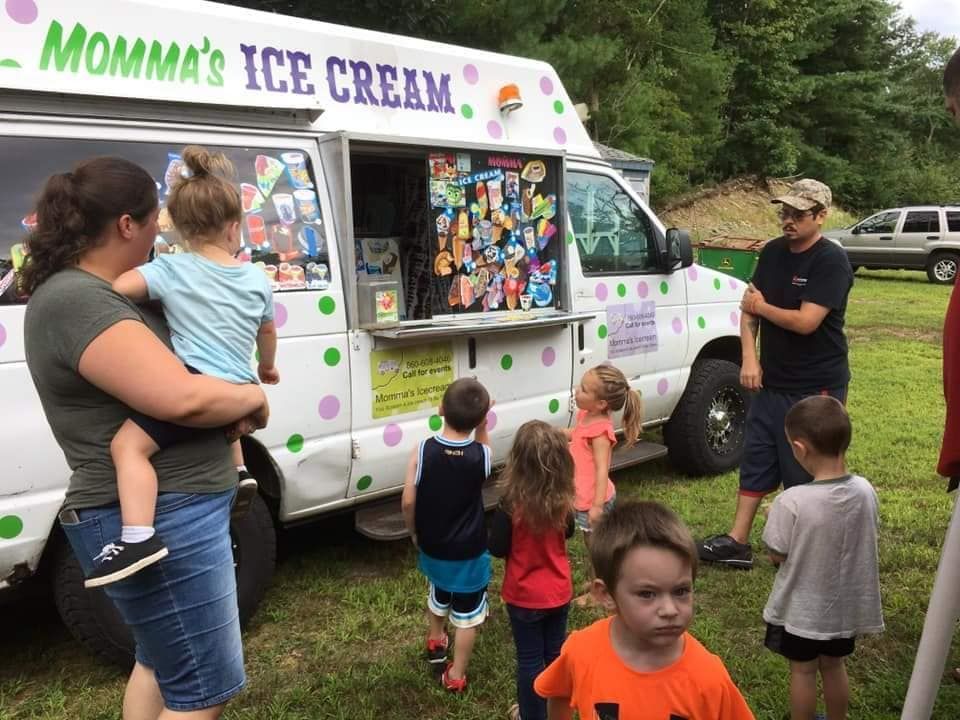A group of people standing outside a white