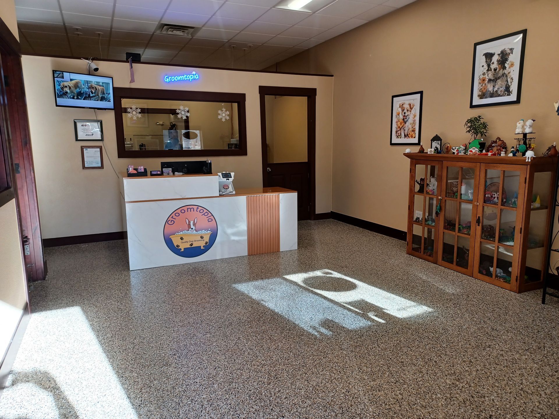 A large room with a reception desk and a tv on the wall