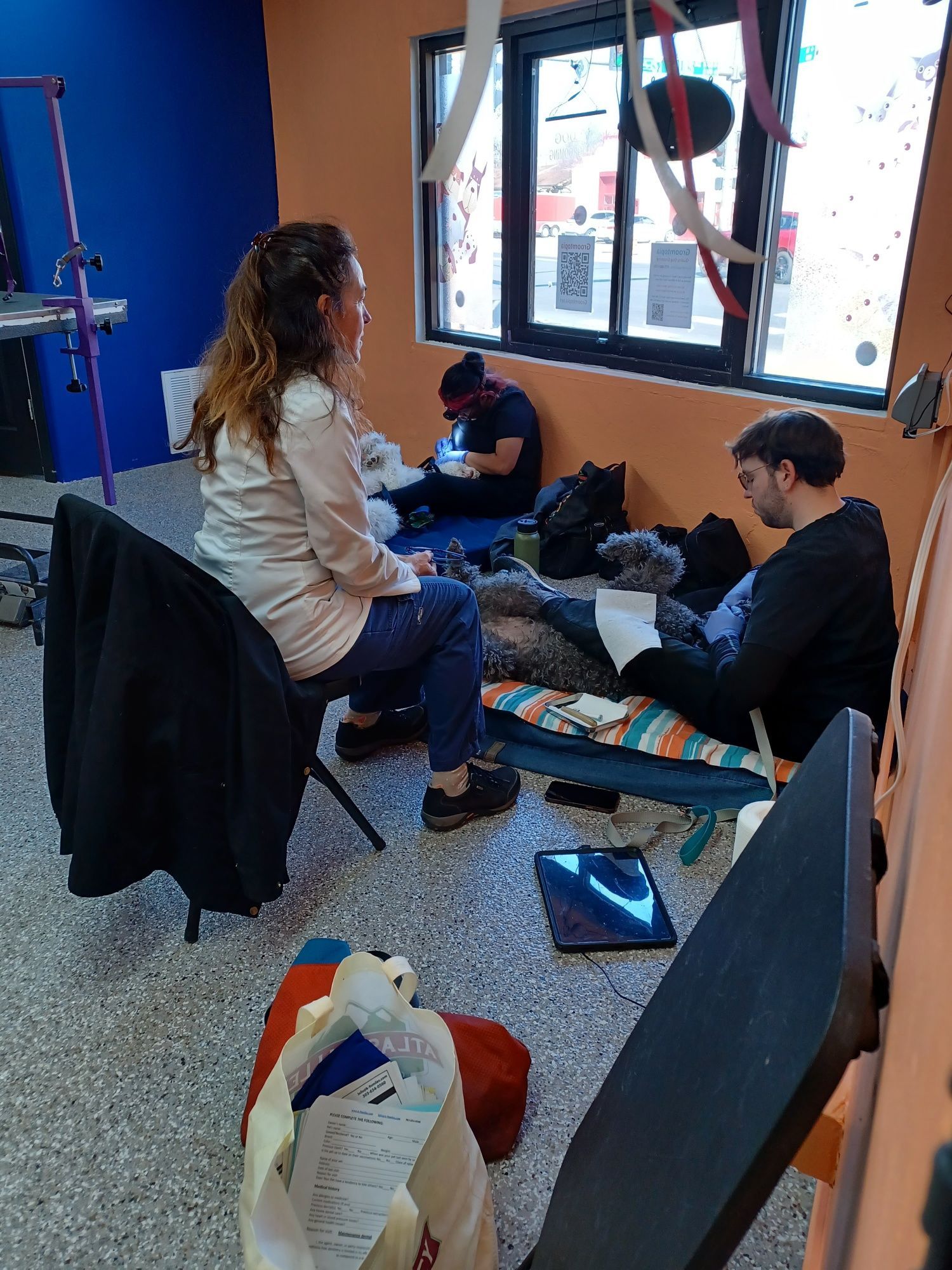 A group of people are sitting on the floor in a room.