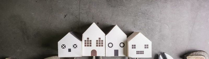 A row of small wooden houses sitting next to each other on a table.