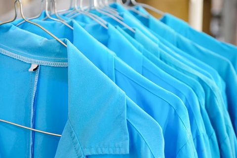 row of cleaned nurse uniforms