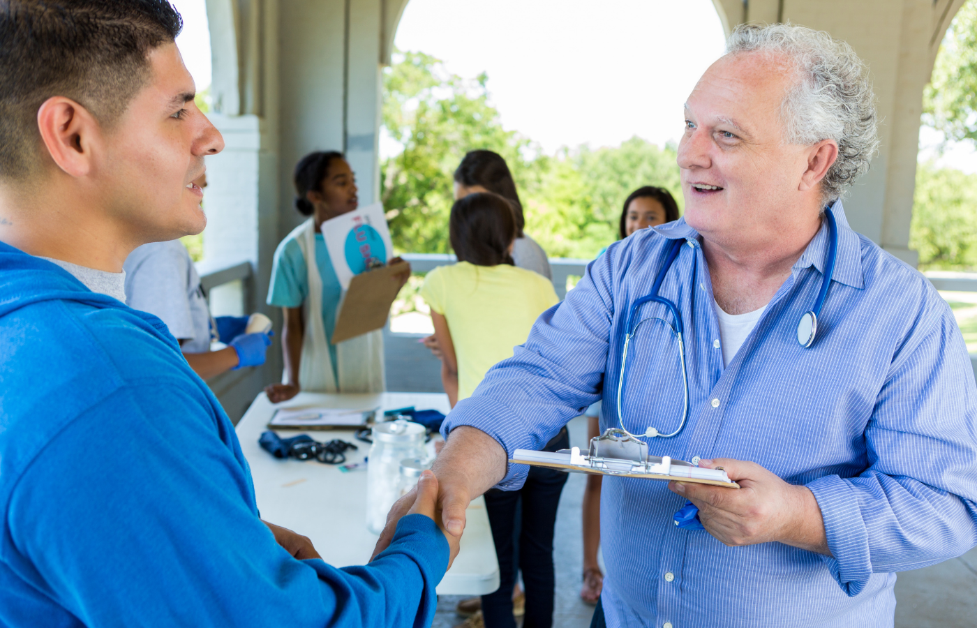 Provider shaking patient's hand at our Summer Health Fair