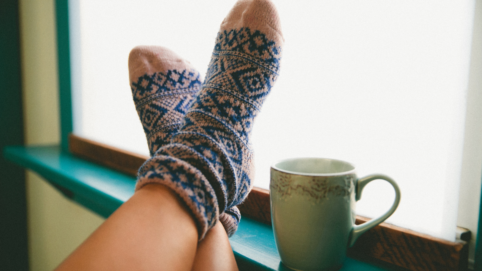Cozy Socks Next to a Window as Someone Doesn't Travel