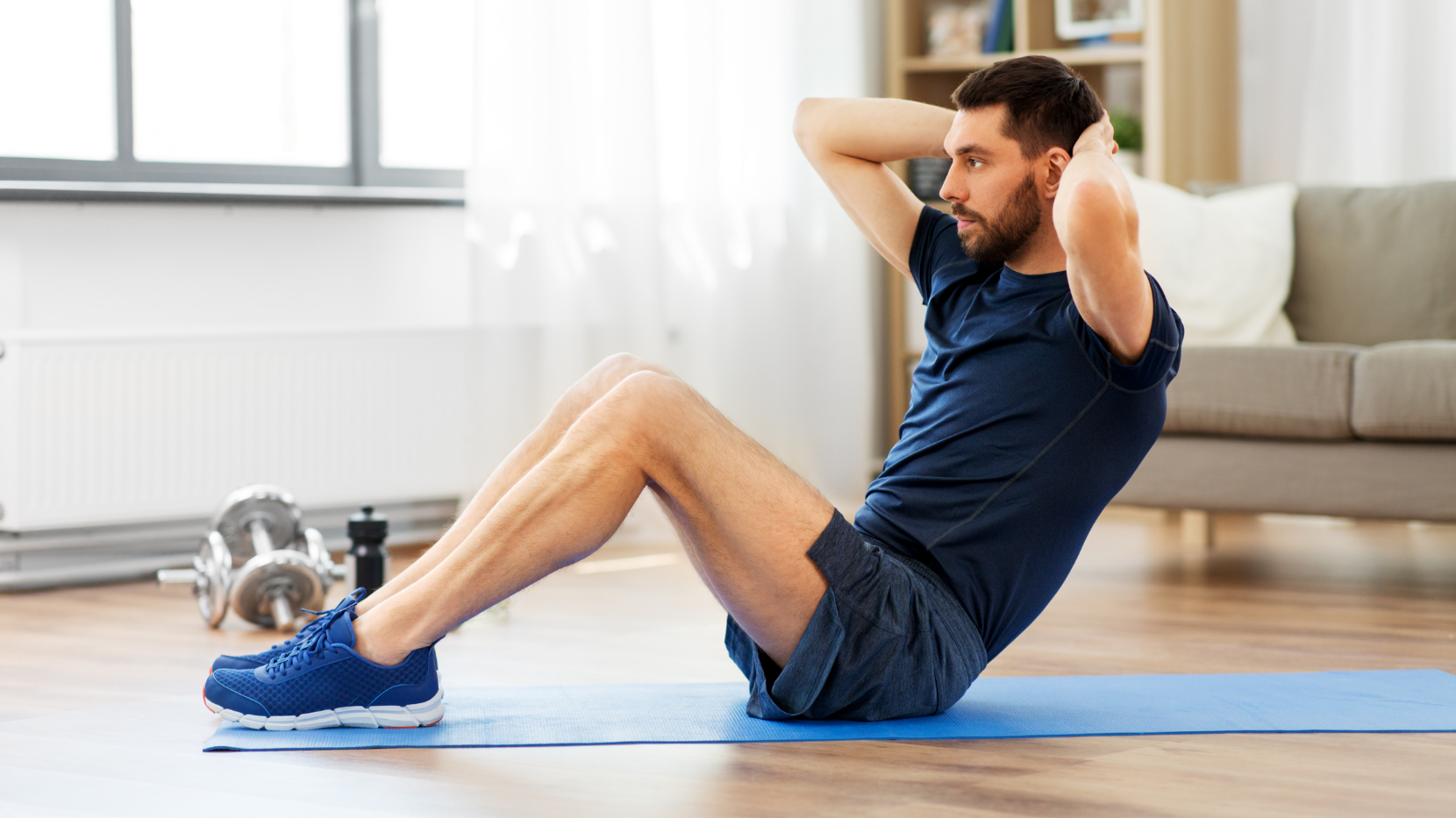 a young man doing sit-ups and staying active and healthy