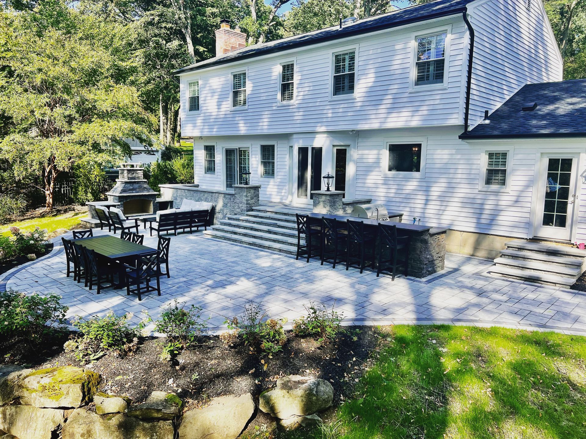 A large white house with a large patio in front of it.