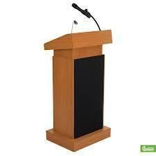 Wooden podium with a microphone, black panel, and a light wood finish.
