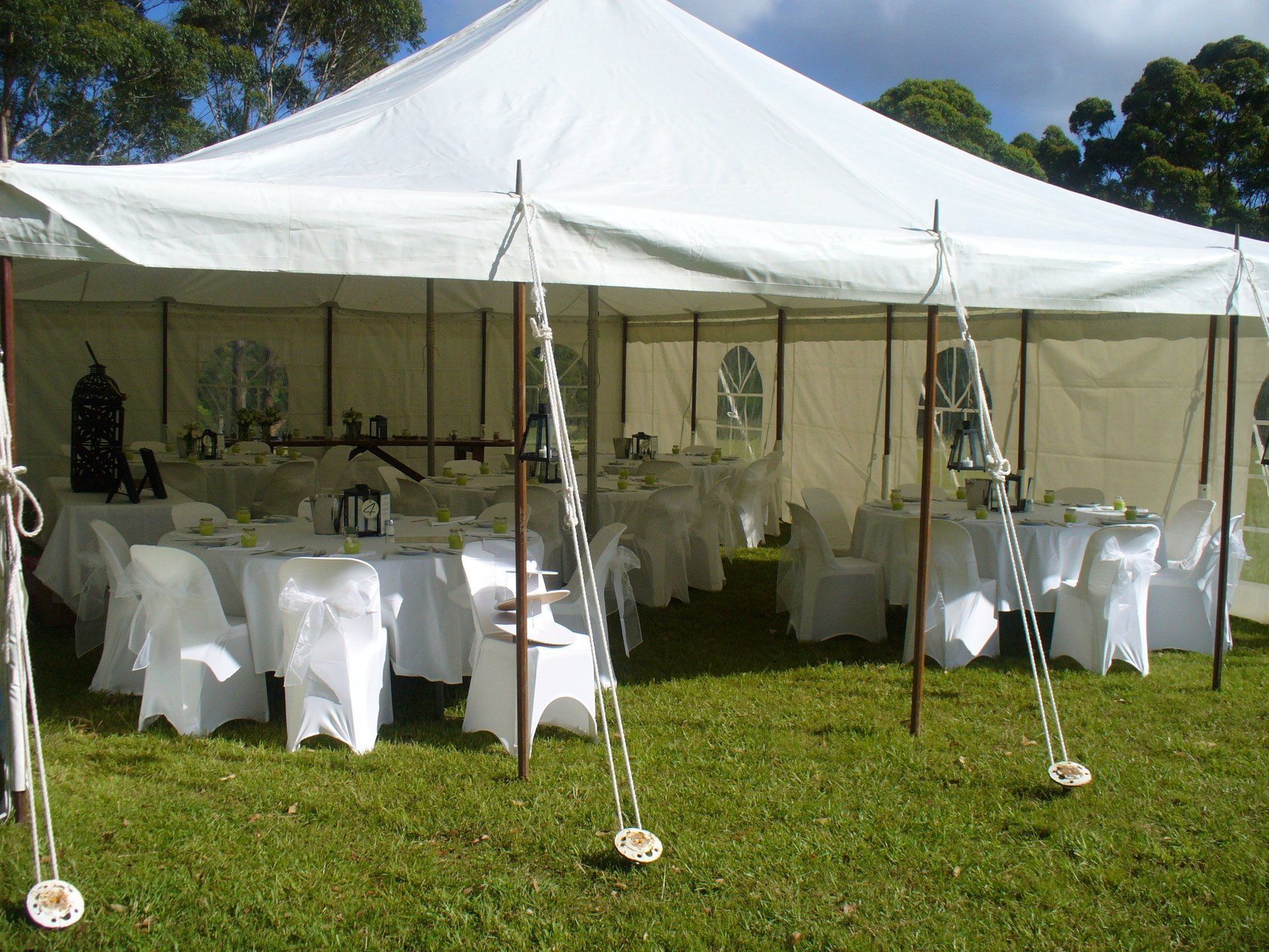 A Large White Tent With Tables And Chairs Inside Of It – Caboolture, QLD - R & R Hire Services