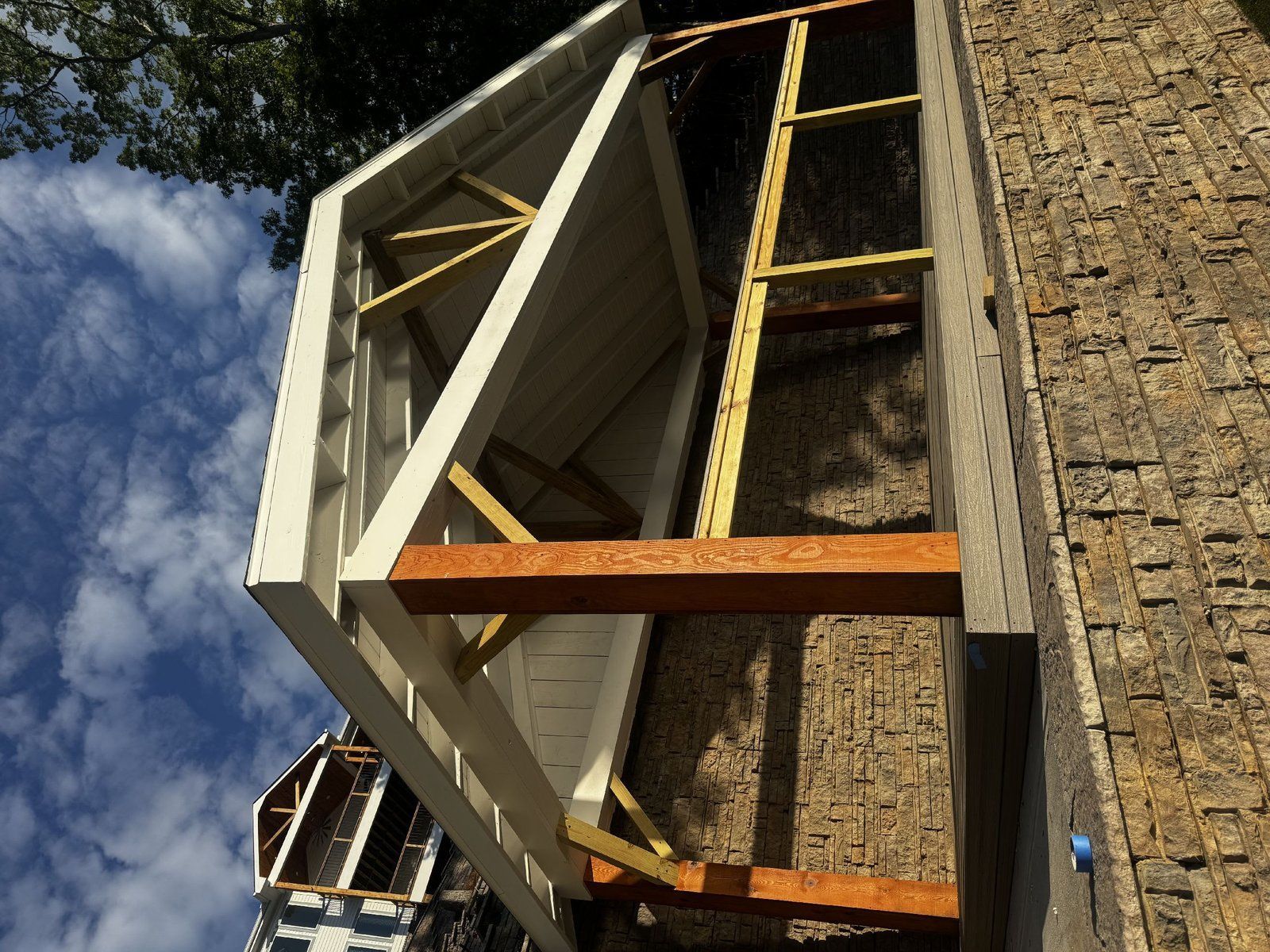 Exterior of a building with a white and wood framed structure
