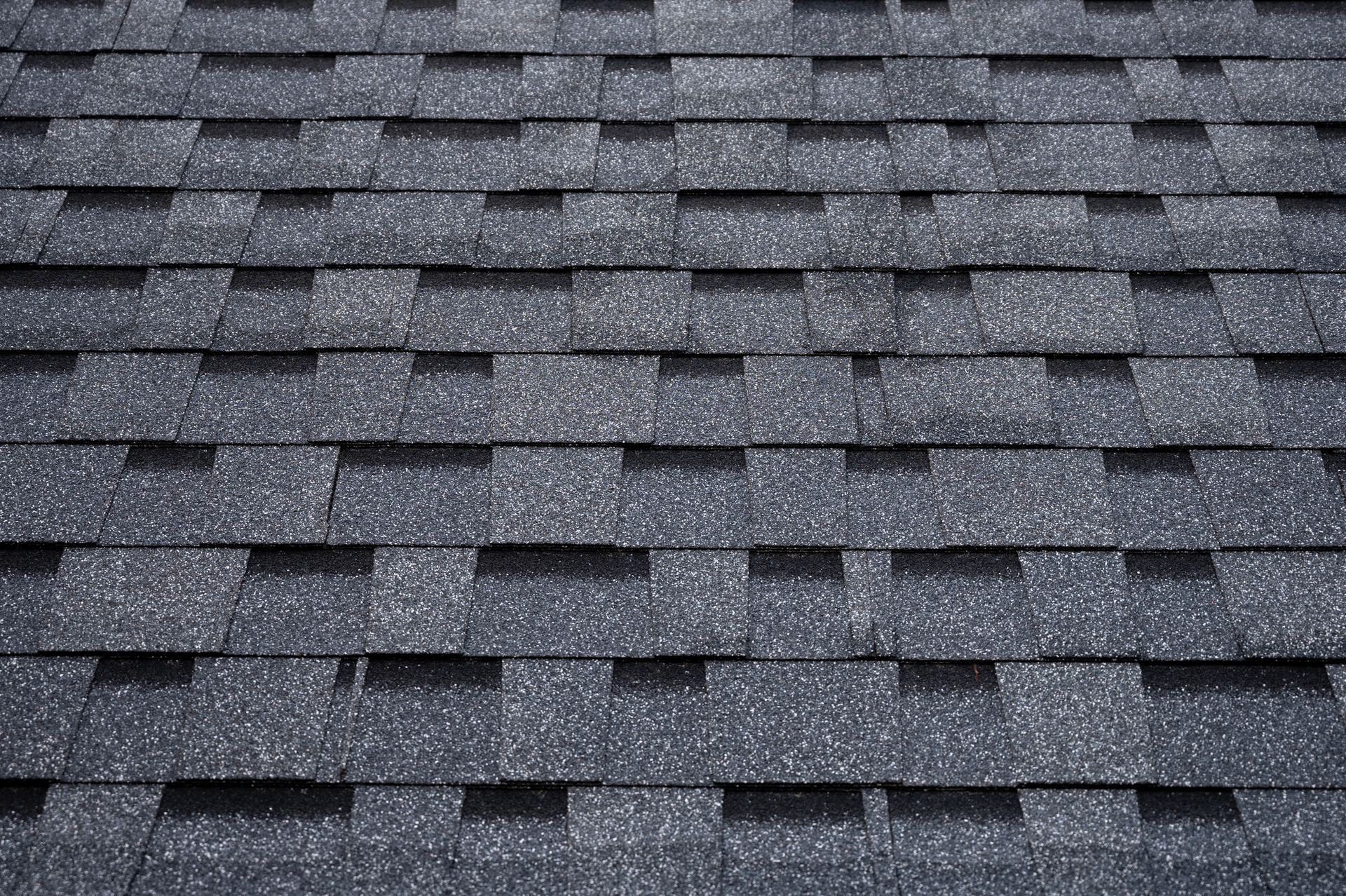Dark gray asphalt roof shingles.