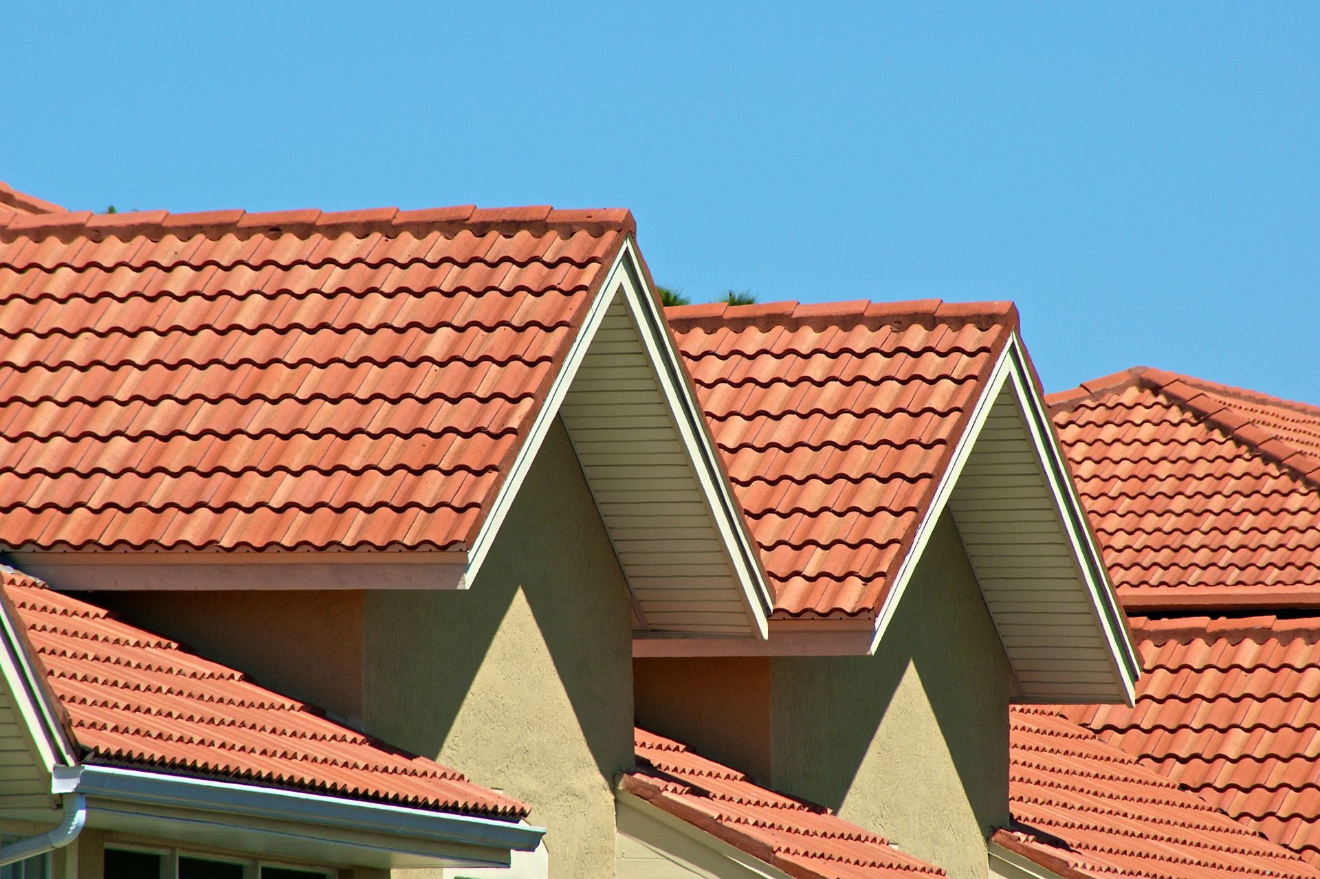 Red tile roofs against a clear blue sky.