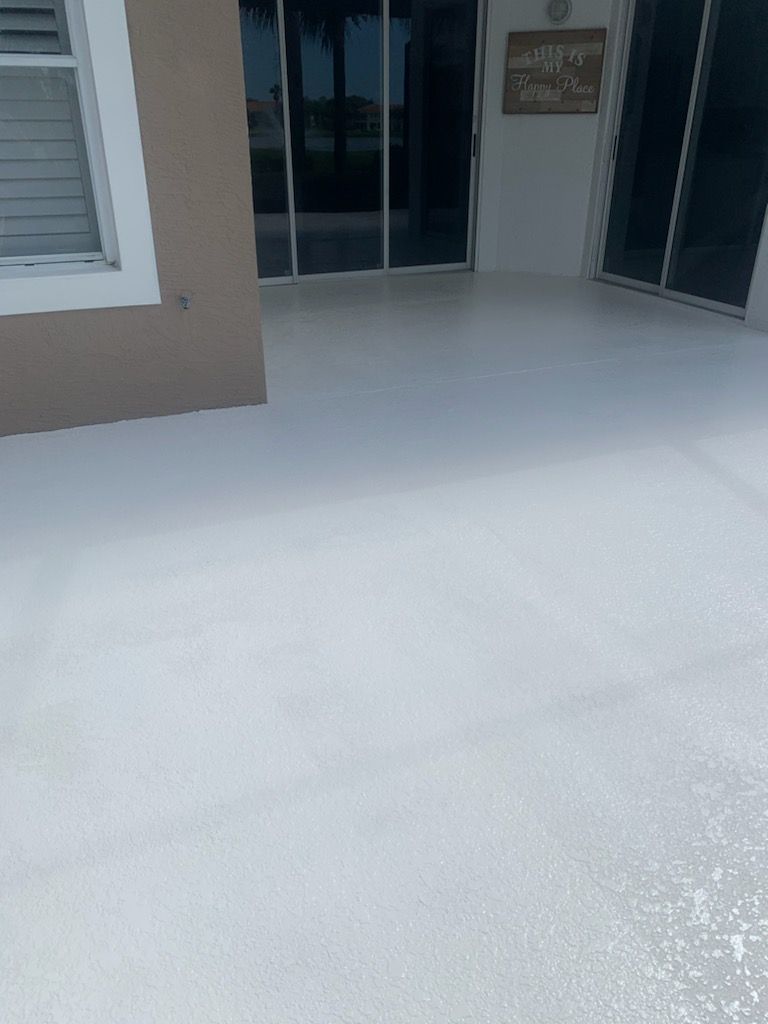 White painted patio with glass doors, house exterior.
