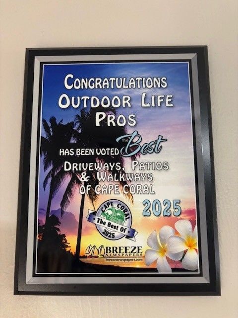 Plaque for "Outdoor Life Pros" voted best for driveways, patios, and walkways in Cape Coral, 2025. Features a palm tree and flowers.