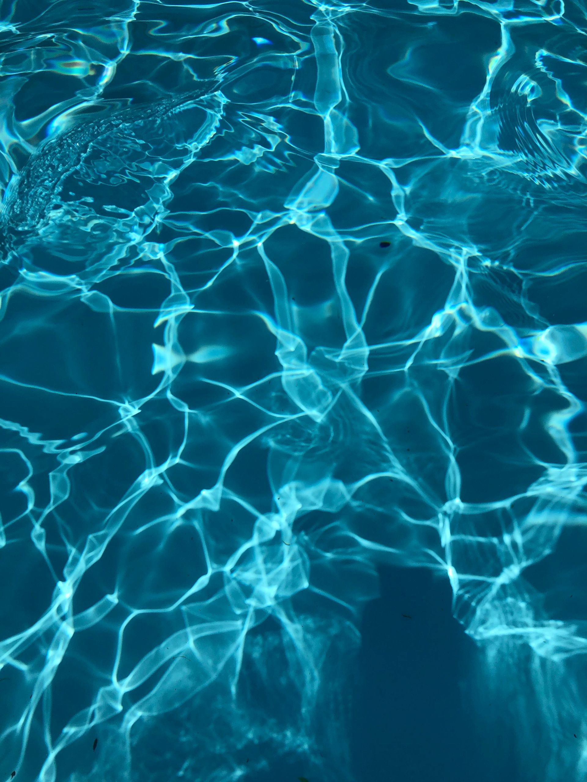 A close up of the water in a swimming pool.