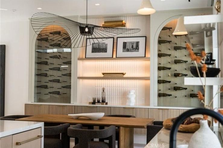 A kitchen with a table and chairs and a wine cellar