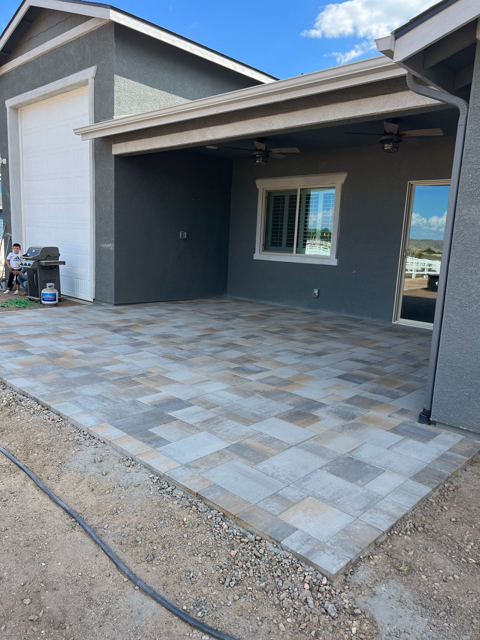 A concrete walkway is being built in front of a house.