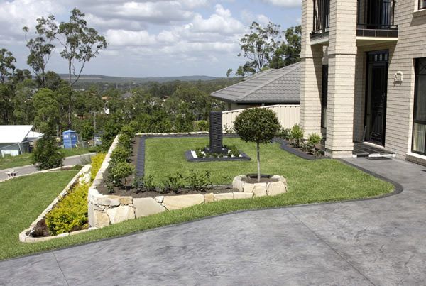 A Large House with A Lush Green Lawn in Front of It — Creating Eden Landscaping In Edgeworth, NSW