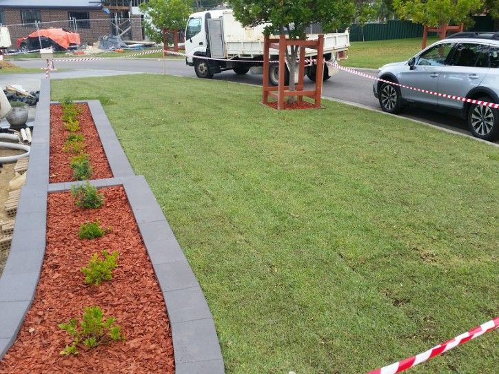 Freshly Laid Green Sod Lawn and Landscaping With Gray Border — Creating Eden Landscaping In Warners Bay, NSW