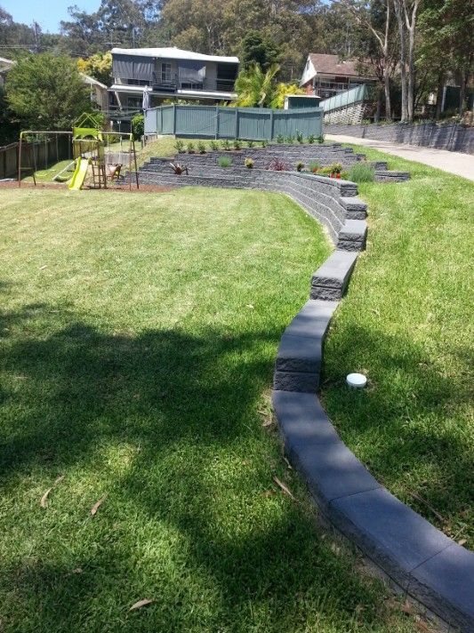 Grassy Backyard With Curved Retaining Wall — Creating Eden Landscaping In Speers Point, NSW