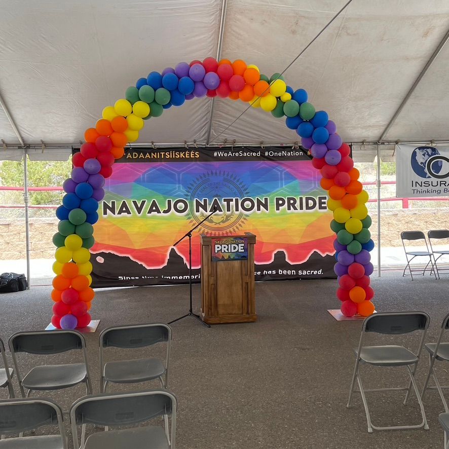A podium in front of a banner that says navajo nation pride