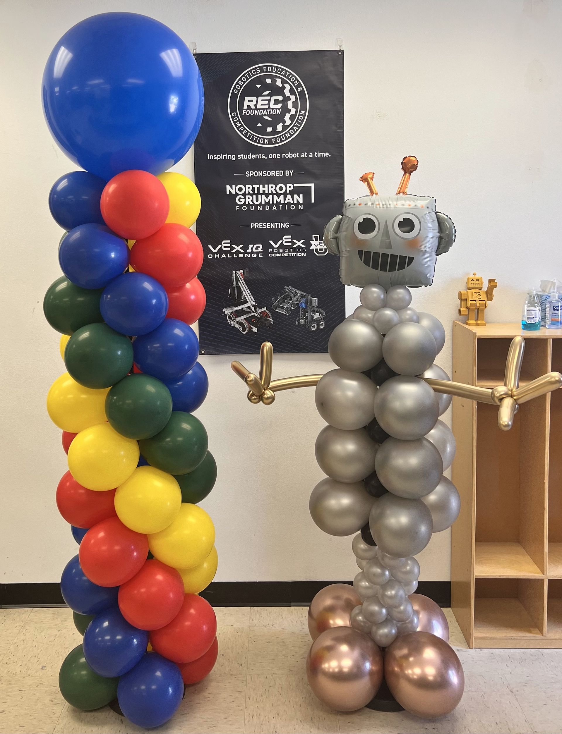 Two balloon columns are sitting next to each other in a room.