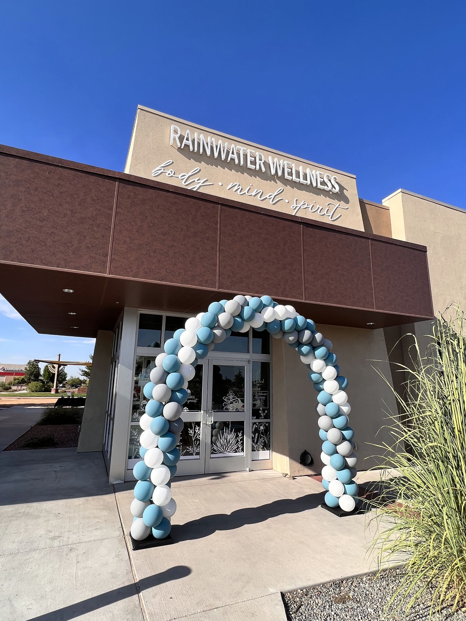 A building with a blue and white balloon arch in front of it