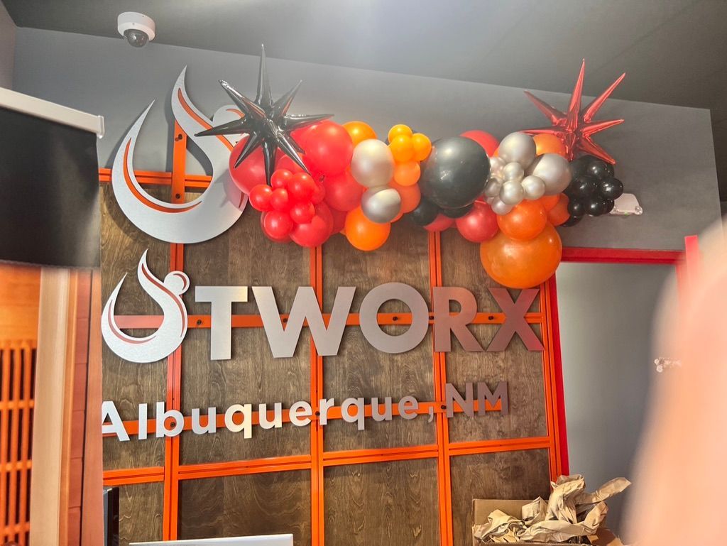 A sign that says stworx on it with balloons around it