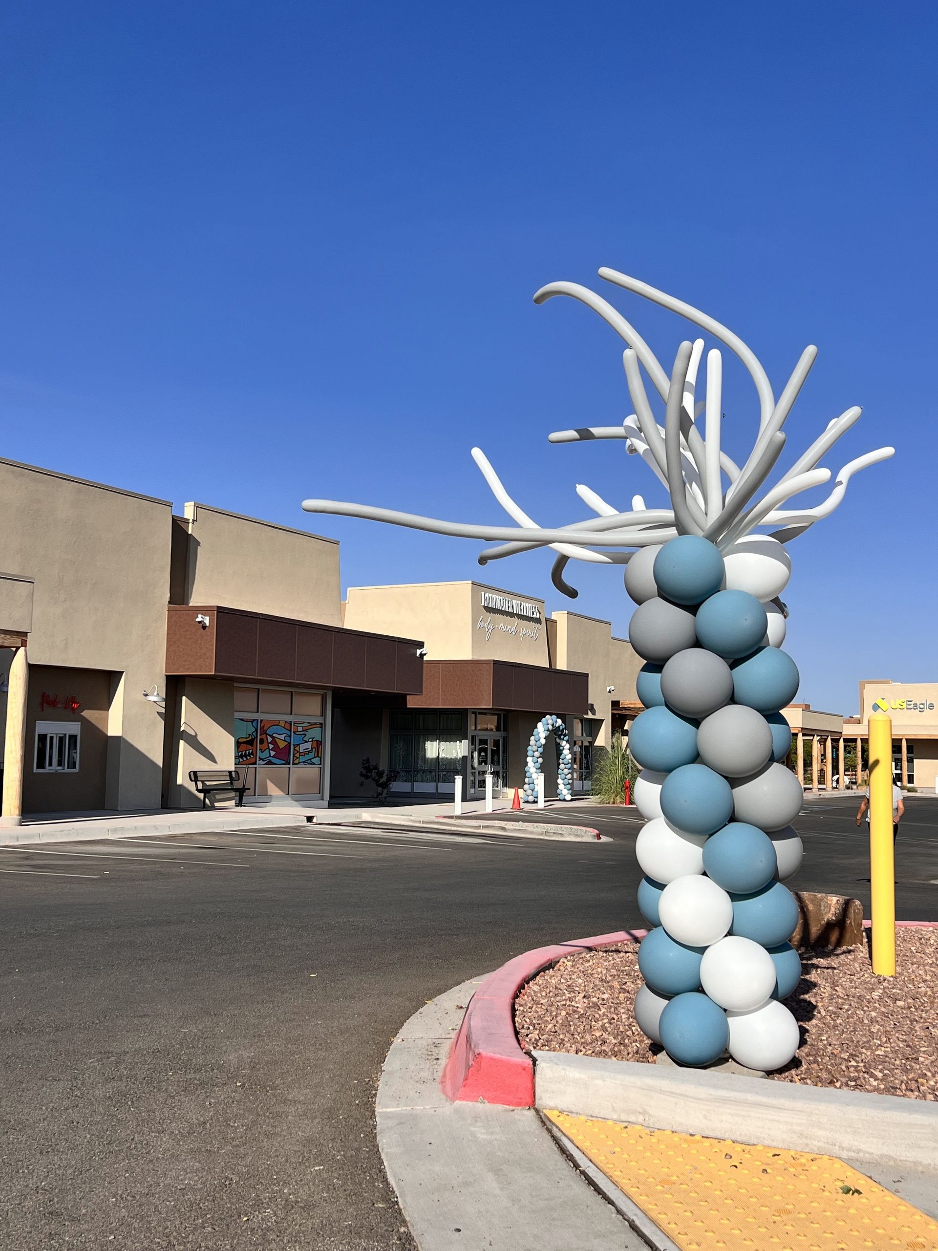 A tree made of balloons in front of a building