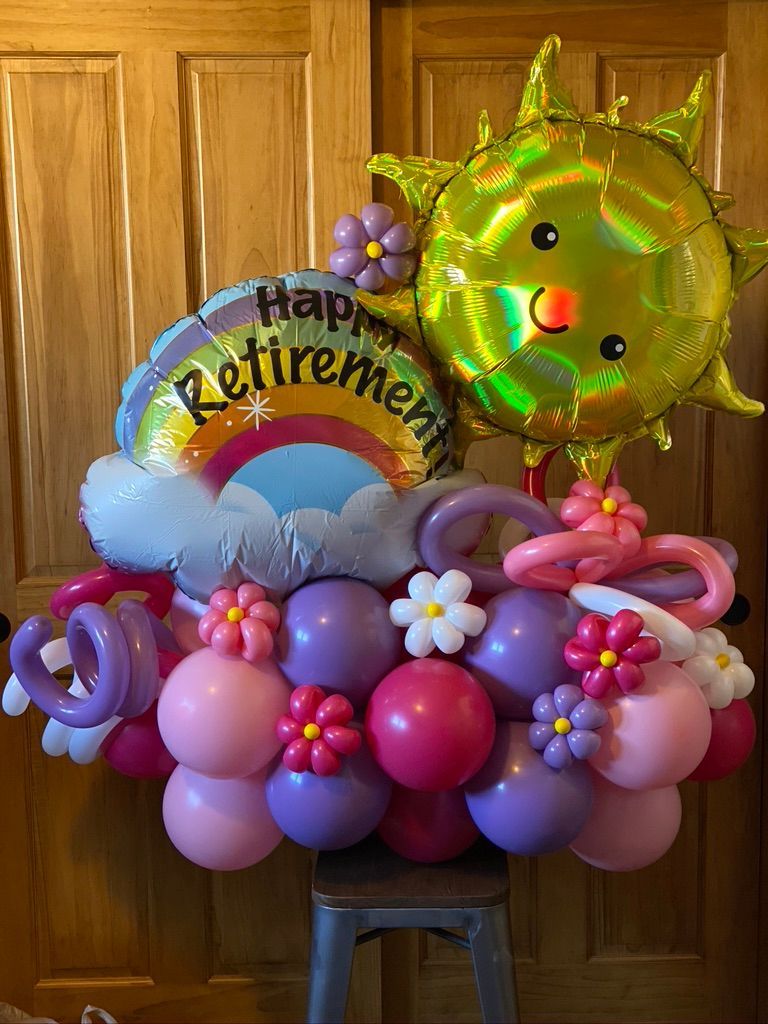 A bunch of balloons are sitting on top of a stool.