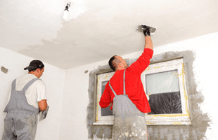 Plasterers working on a ceiling