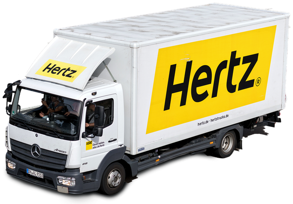 Hertz rental truck, white cab and box with yellow Hertz logo, parked outdoors.