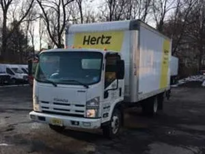 White Hertz rental box truck parked on asphalt.