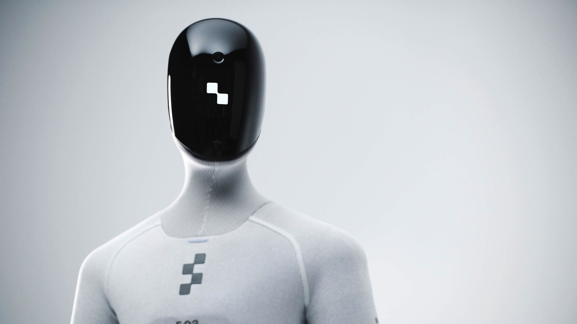 Chrome-colored humanoid robot with a black head covering and clear face shield stands in a modern building.