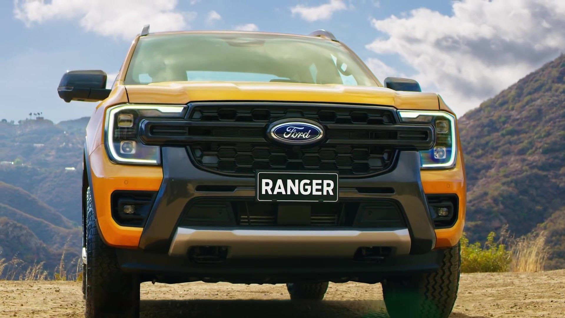 Yellow Ford Ranger truck, black grill, 