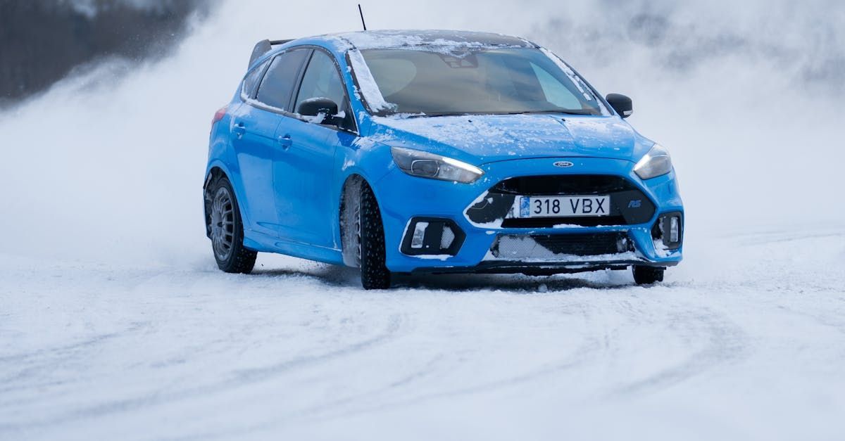 A blue ford focus rs is driving on a snowy road.Garage Auto Service & Repair