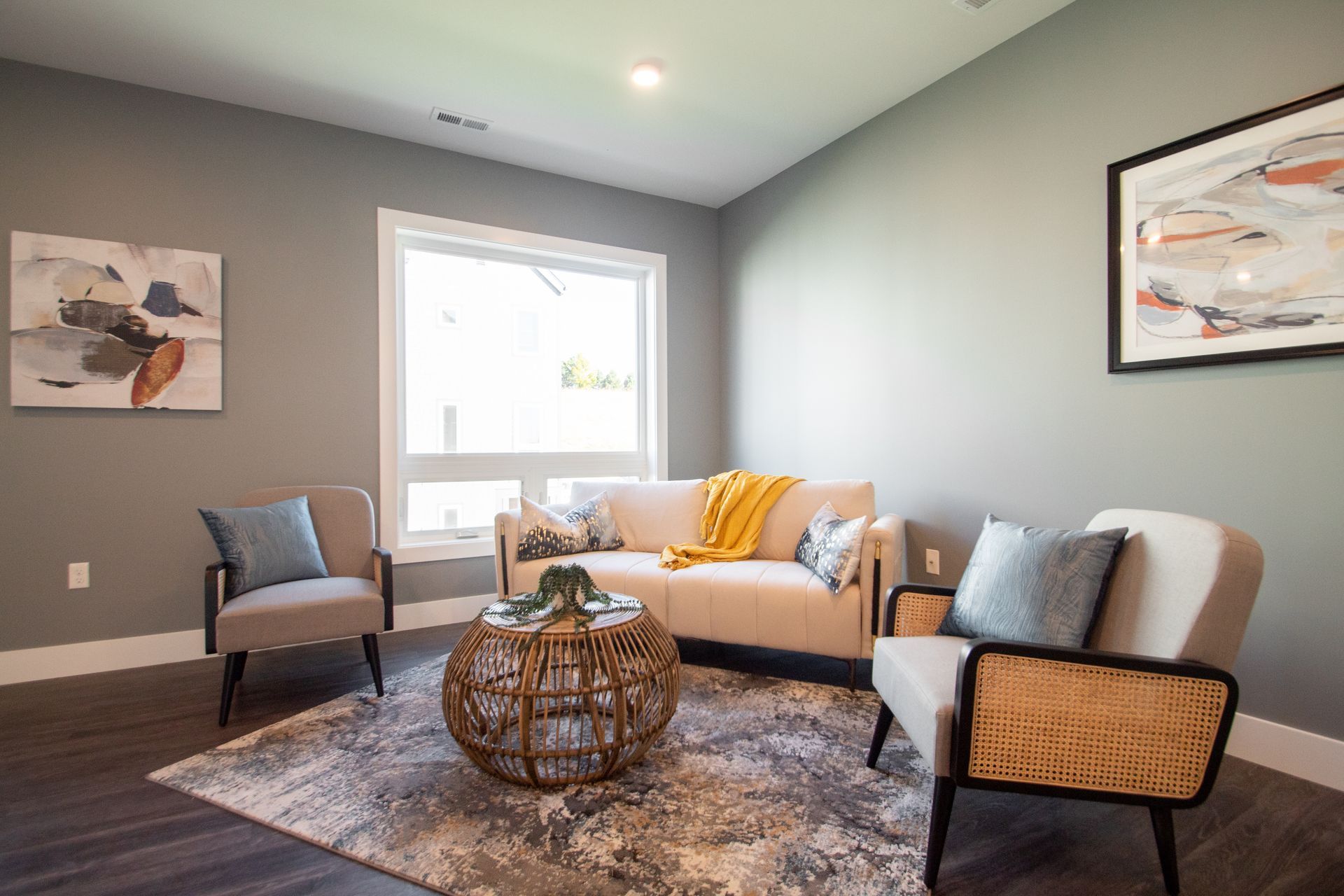 A living room with a couch , chairs , and a coffee table.
