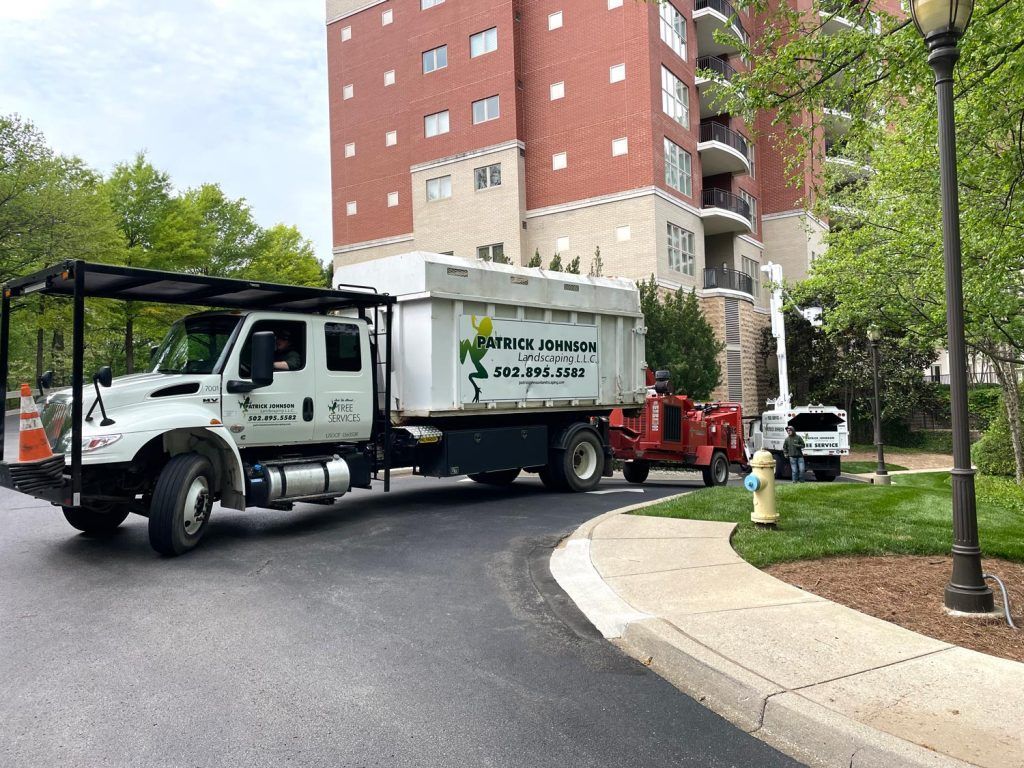 A truck is parked on the side of the road in front of a building.