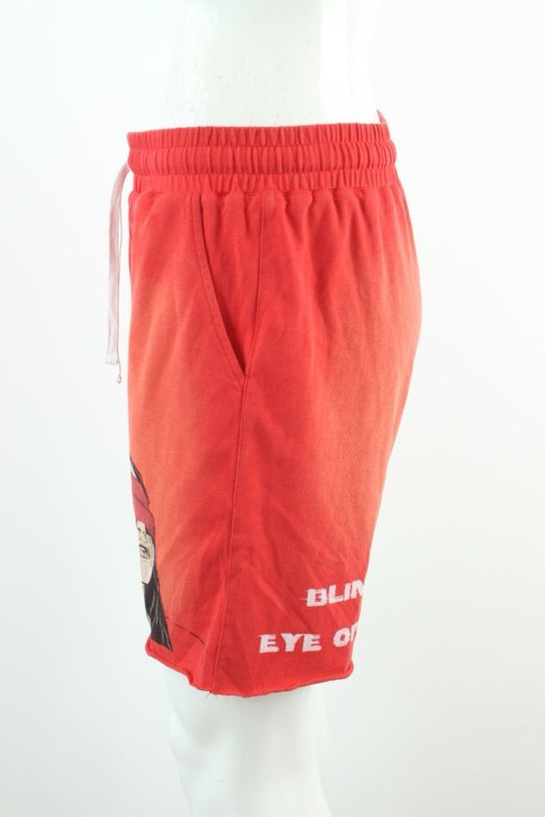 Red shorts with white drawstring, graphic of a blindfolded woman. 