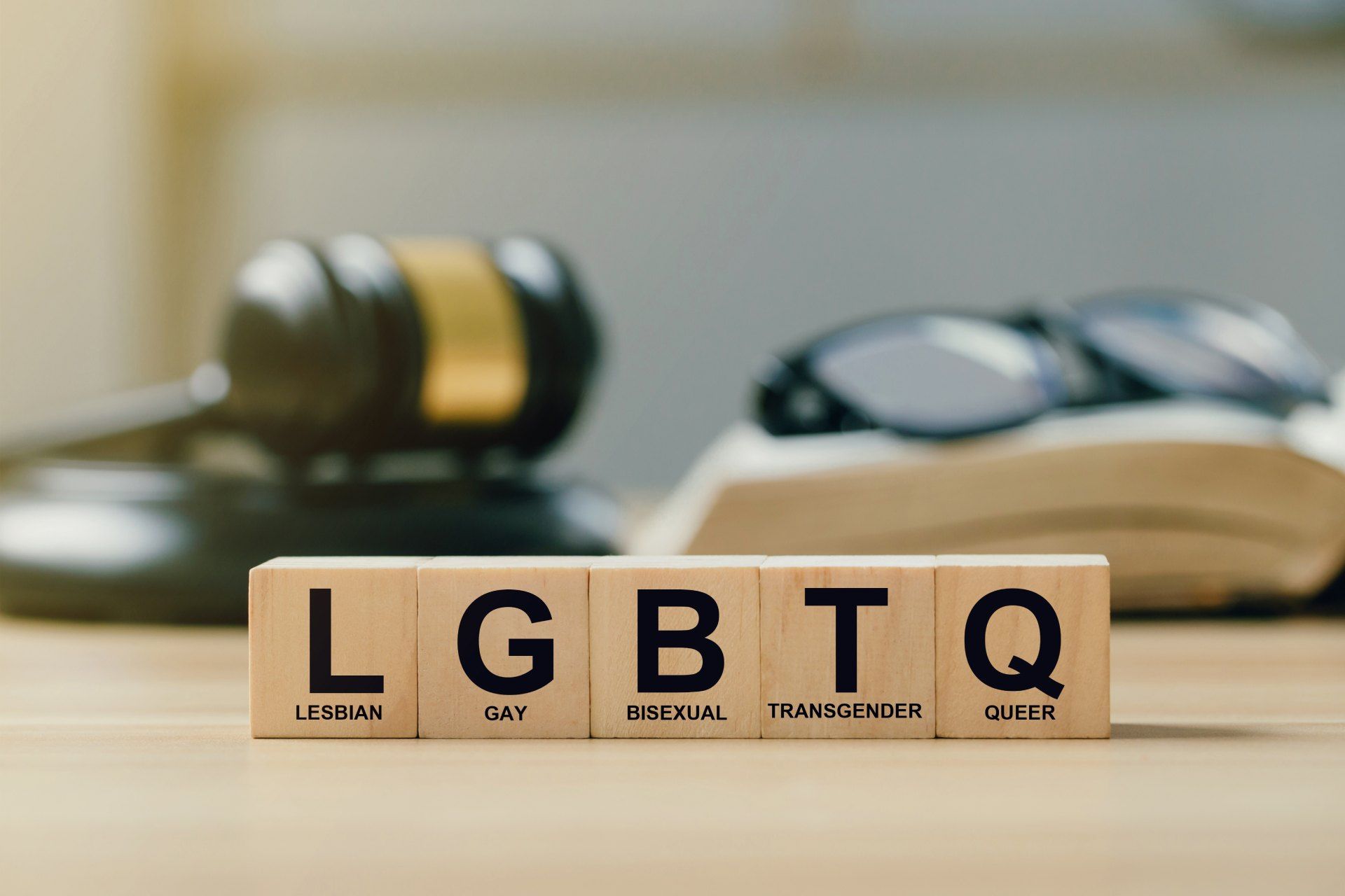 The word lgbtq is written on wooden blocks on a table.